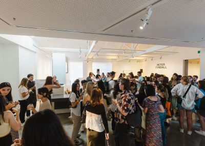 A gathering of people enjoy socialising at a Buxton Gallery opening