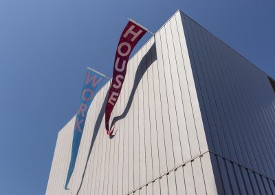 two large pennant flags flying from a a building